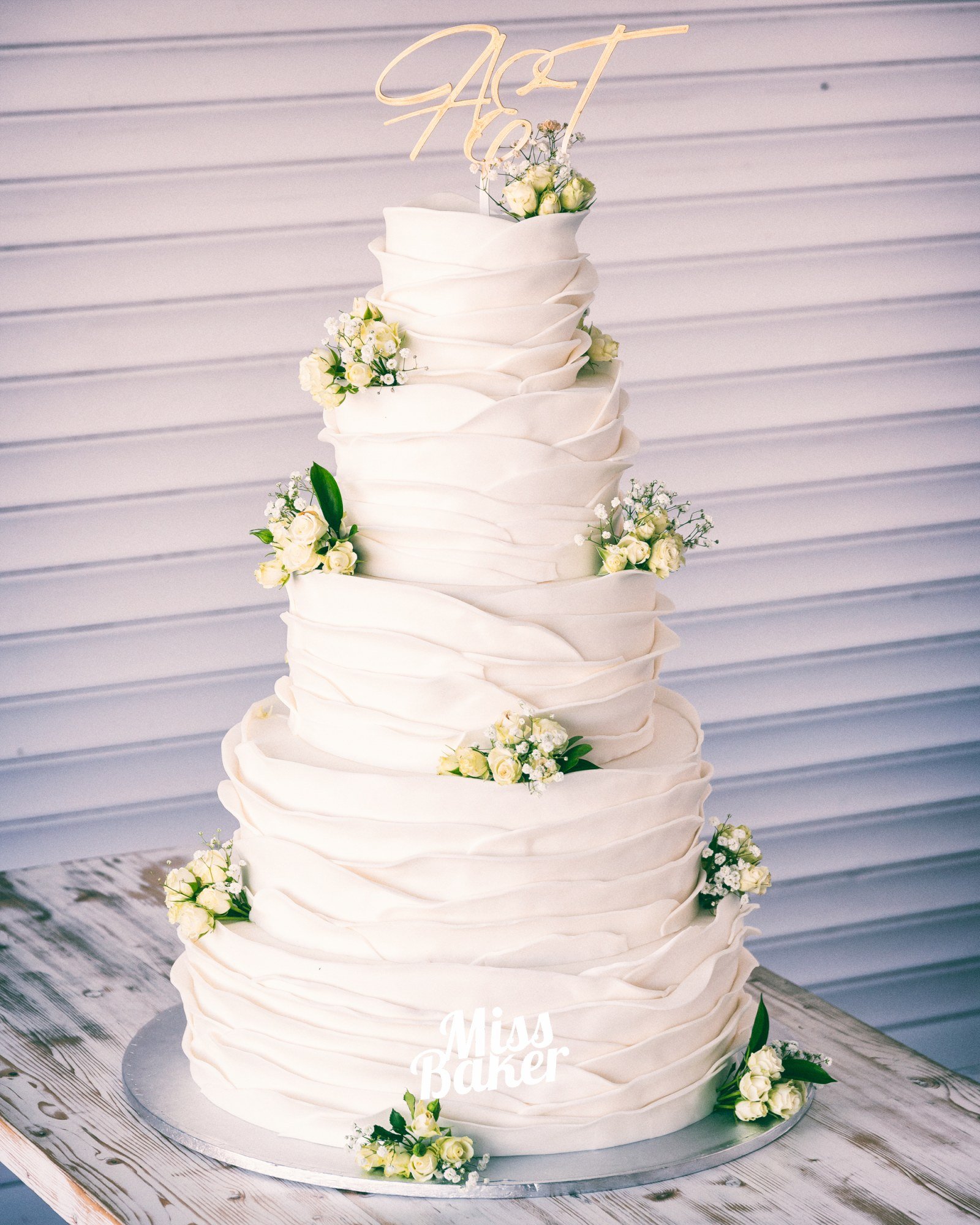 Torturi de nuntă de la Miss Baker — cinci niveluri, valuri fondant, buchete florale mici
