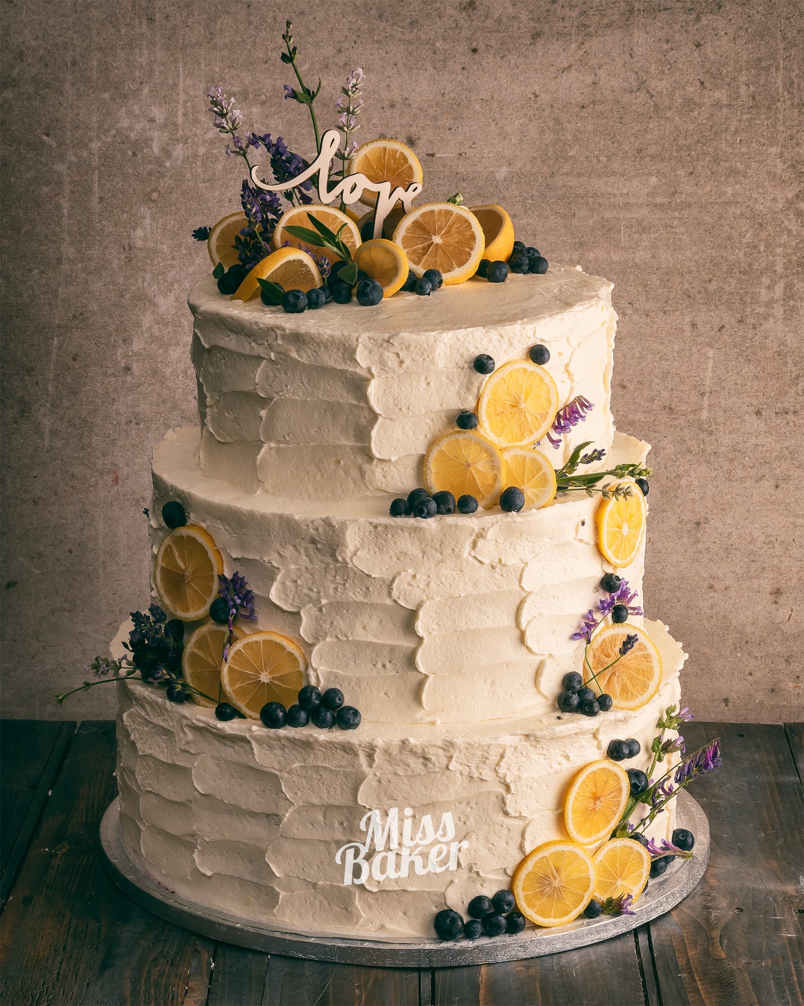 Torturi de nuntă de la Miss Baker — trei niveluri, detaliu texturat, aranjament floral superior